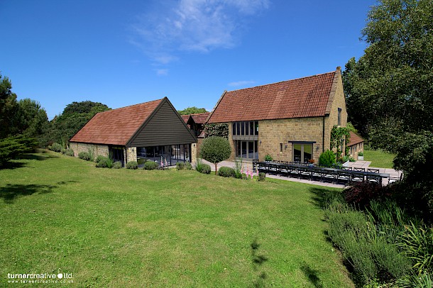 Photo fit illustration of stone barn conversion with pool house